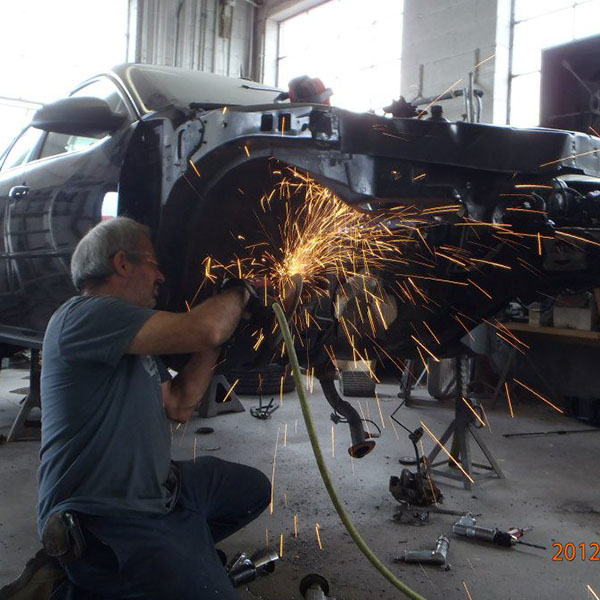 man fixing car wheel